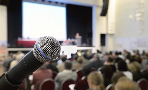 Microphone at conference. Dynamic microphone against the background of convention center. Real photo.